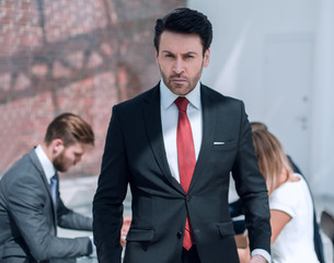 Executive businessman standing in the office.