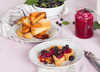 Delicious toasts bread with homemade currant jam with fork and knife