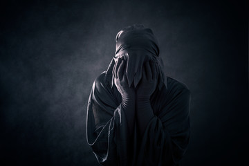 Scary figure in hooded cloak