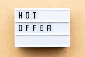 Light box with word hot offer on wood background