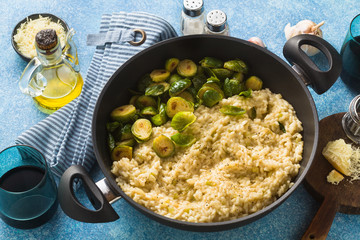 Italian spring risotto with Brussels sprouts and parmesan cheese on the table. healthy food for the whole family, party or restaurant menu