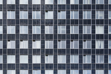 Front view on a facade of modern office building as  texture, background, abstract