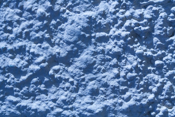Fototapeta na wymiar Texture of blue stone wall with rough stucco surface