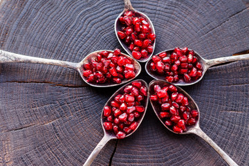 Ripe red grenade on a wooden background