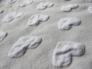 Grey heart shaped knitwear texture