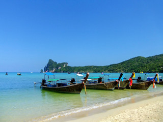 Longtail boats anchored at Ao Loh Dalum beach on Phi Phi Don Island, Krabi Province, Thailand