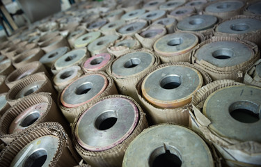 Beautiful metal industrial machinery steel cogs in a rustic industrial factory setting. Well used processing machinery parts.