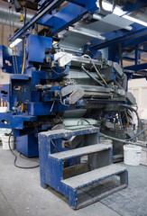 Beautiful metal industrial paint mixer machinery mixer in a rustic industrial factory setting. Well used processing machinery parts.