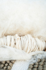 Fototapeta na wymiar Merino's sheep wool on a spinning wheel 