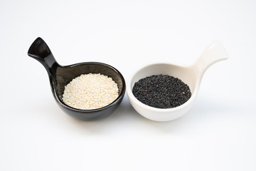 white sesame Sesamum indicum and black sesame Sesamum radiatum seed on small bowl on white background