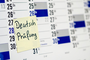 German examination on notepad written on calendar in german