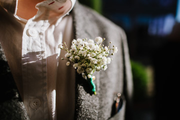 Beautiful buttonhole on the grooms jacket close up