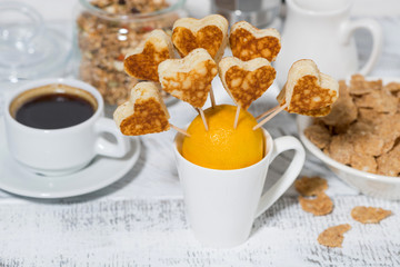 conceptual mini pancakes in the form of hearts for breakfast, top view