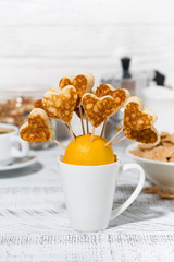 conceptual mini pancakes in the form of hearts for breakfast, vertical