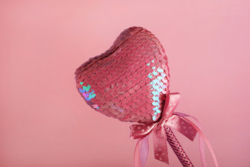 One red heart on a pink background, lightness and romance for Valentine's Day, Women's Day, March 8.