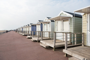 brighton, england, 05/05/2018 Beautiful retro vintage wooden seaside huts on a promenade on the coast. Sunny beach traditional holidays with a neutral pastel colour. Wooden seaside buildings.