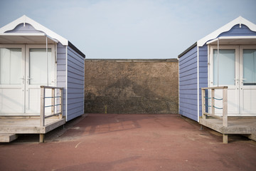 Fototapeta na wymiar brighton, england, 05/05/2018 Beautiful retro vintage wooden seaside huts on a promenade on the coast. Sunny beach traditional holidays with a neutral pastel colour. Wooden seaside buildings.
