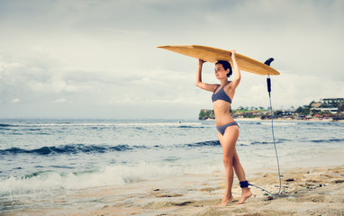 Girl with a surfboard. The girl on the beach. Bali. Journey. Travel.
