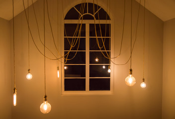 glowing bulbs in the room, interior room with a window