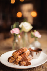 Cinnamon sugar dusted churros with chocolate sauce. Concept of food, dessert and baking. Traditional Mexican food.