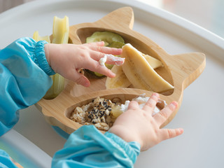 Baby eating by hands, Baby eating organic bio vegetables with BLW method, baby led weaning. Happy...