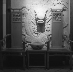 Chinese chairs on the side of a street in Singapore's Chinatown at night shot with black & white analogue film photopgrahy