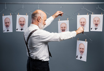 Senior businessman choosing his portraits