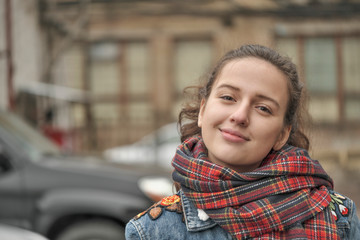 Beautiful attractive girl in a red checkered scarf