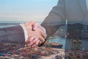 Double exposure of business partner handshake and Container ship in export and import business and logistics cargo terminal background