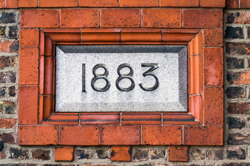 1883 sign on brick wall