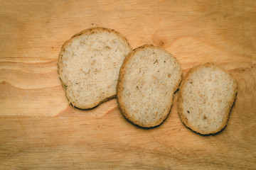 Pieces of bread on light wood