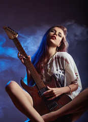 Girl playing the electric guitar