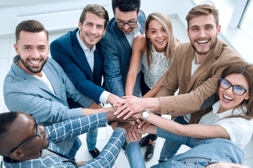 close up.young business team folded their hands together