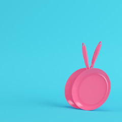 Pink frying pans on bright blue background in pastel colors