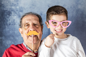 Grandfather and grandson having fun together at home.