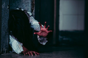 Portrait of asian woman make up ghost face with blood,Horror scene,Scary background,Halloween poster,Thailand people