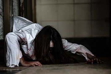Portrait of asian woman make up ghost face with blood,Horror scene,Scary background,Halloween...