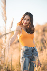 Portrait of beautiful asian woman at the field on sunset,Thailand people