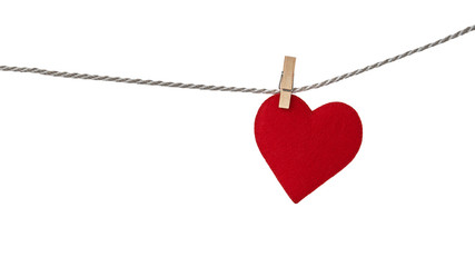 Red felt valentine heart hanging from a rope fixed by wooden clothespin isolated on white background