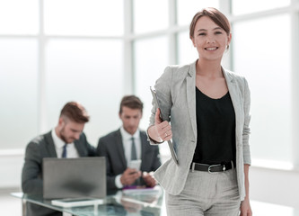 Executive young businesswoman standing in the office.