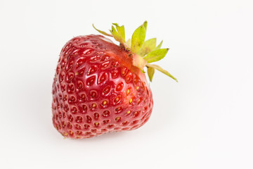 single ripe red strawberry - fragaria