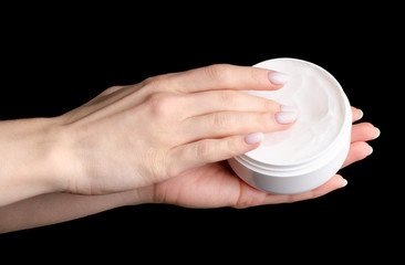 White cream container in hand beauty on black background isolation