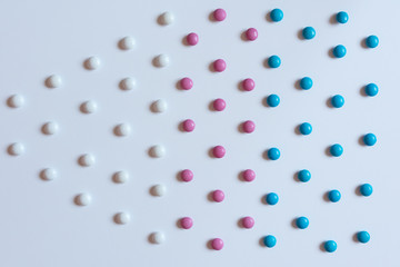 Pile colorful chocolate coated candy background texture pattern. Geometric concept