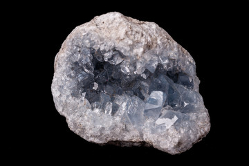 Celestine mineral stone macro on microcline on black background