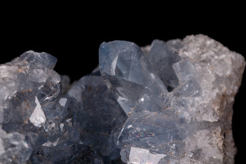 Celestine mineral stone macro on microcline on black background