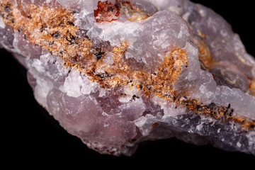 Macro pink Smithsonite mineral stone on microcline on black background