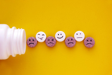 Pills medical. With painted faces and no pictures on yellow background