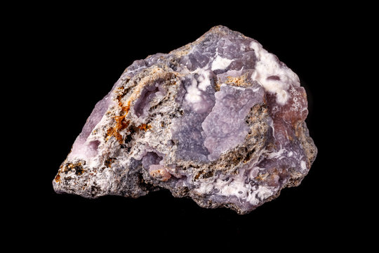 Macro pink Smithsonite mineral stone on microcline on black background