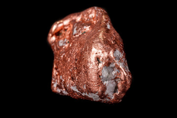 Macro mineral stone of a copper nugget on a microcline on a black background