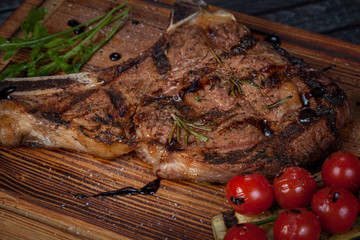  juicy, fried, tender steak with vegetables and sauces on a special stand